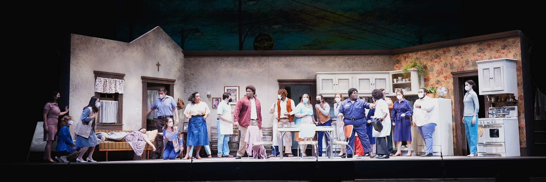 Many students on stage performing in the 2022 production of Highway 1, USA. Some students are masked, some are unmasked.